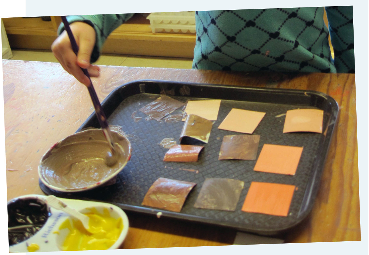 child painting cards on a plate