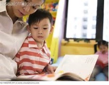 boy listening to teacher read to him