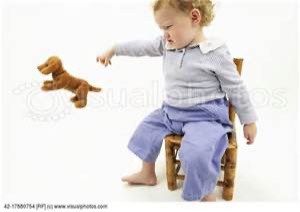 baby in a chair throwing stuffed dog