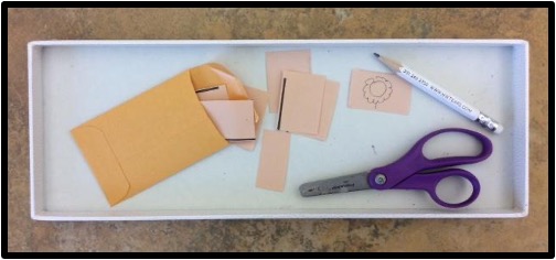 Cutting, drawing and placing in an envelope tray