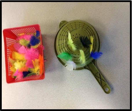 feathers and colander for hand eye practice