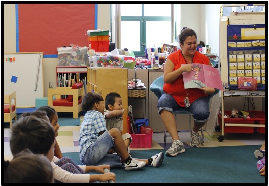 teacher reading to a group of students