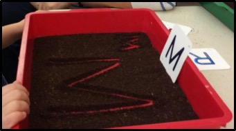 red bin with letter M in coffee grounds 