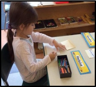 child writing her name