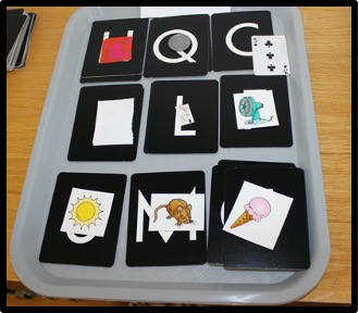 letter sound activity with 9 letters on a baking sheet and pictures with corresponding beginning sounds placed on top of a letter