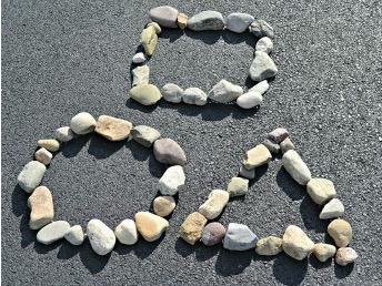 A circle, square and triangle made with rocks