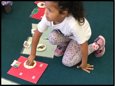 student putting their ticket on choice board