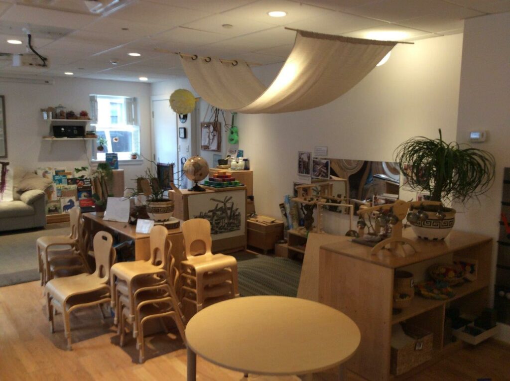 image of a classroom with light wooden furniture and natural tone rugs and walls. 