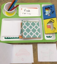 Tray with stencils, paper, coloring pencils and vocabulary word cards