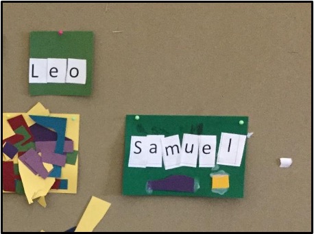 Child's name strip cut up and glued on  a piece of paper