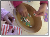 Two children ripping strips of paper