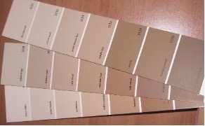 Paint sample strips in shades of browns that match shades of people. 