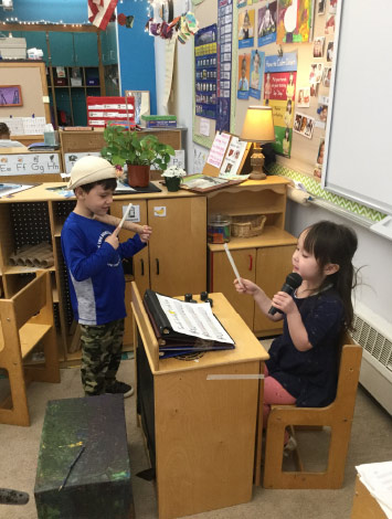 two children pretend with musical instruments