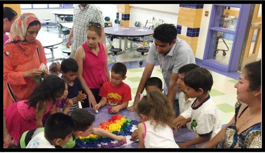 Family standing around a table with children Family standing around a table with children