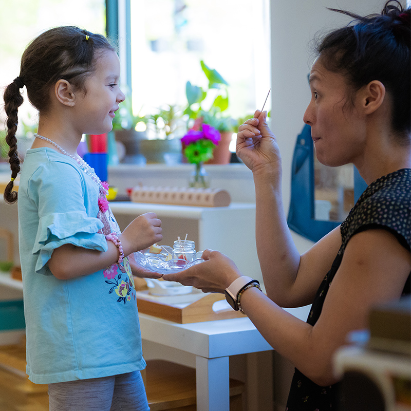 teacher showing child a card