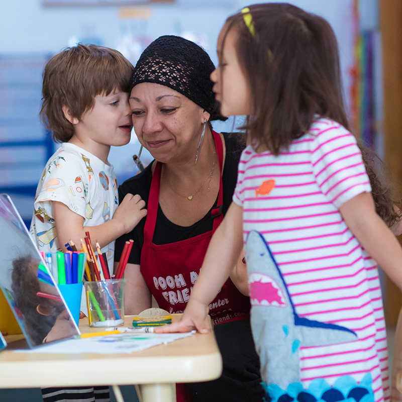 Family standing around a table with children